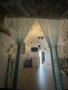 a room with two green curtains in a building at Casa Mimmo in Ostuni