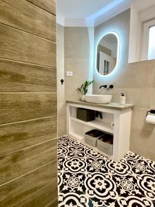 a bathroom with a sink and a mirror at Cloos - Elegant Residence with Panoramic View in Braşov