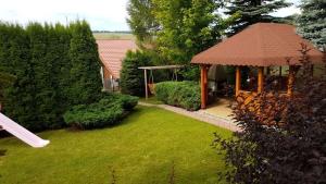 a gazebo in a yard with a green lawn at Apartmán Šuňava in Vyšnie Šuňava