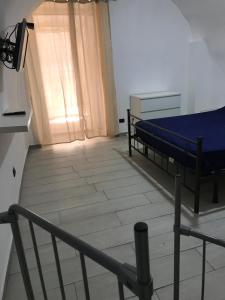 um pequeno quarto com uma cama e uma escada em Casa poli em Portici