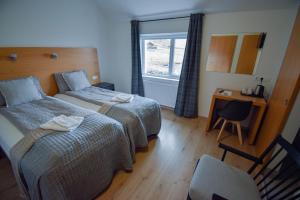 A bed or beds in a room at Glacier World - Hoffell Guesthouse