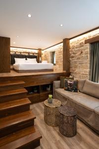 a bedroom with a bed and a couch in a room at Bodrum Suites in Ioannina