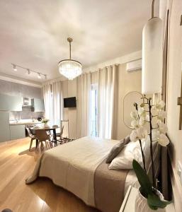 a bedroom with a large bed and a dining room at Sea Pearl Luxury Rooms in La Spezia