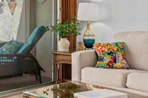 a living room with a couch and a table at "Makani Moana" at Keauhou Resort #104, Entire townhome close to Kona in Kailua-Kona