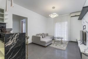 a living room with a couch and a table at Luna 2-BR in Mar Mikhael in Beirut