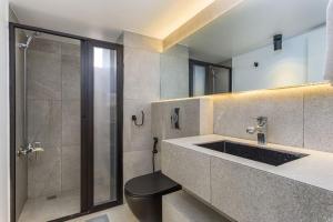 a bathroom with a shower and a sink and a toilet at Luna 2-BR in Mar Mikhael in Beirut +11 photos