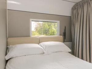 Ένα ή περισσότερα κρεβάτια σε δωμάτιο στο Buckland House Pod