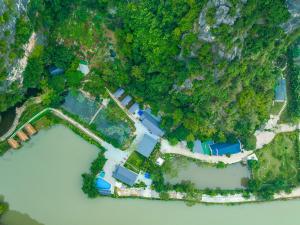 an aerial view of a house next to the water at Hoang Minh Mountainside Villa in Ninh Binh