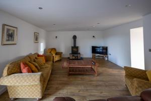 a living room with two couches and a tv at 'Sgubor in Menai Bridge