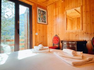 a bedroom with a bed with two towels on it at Mansarda Val di Sangro in Rocca Cinquemiglia
