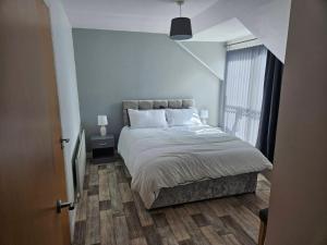 a bedroom with a large bed and a window at Skyview retreat in Derry Londonderry