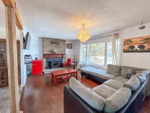 a living room with a couch and a fireplace at Spacious 5BR home. Close to everything! in Gatineau