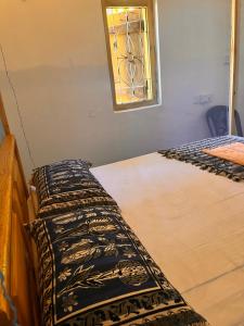 a room with two beds and a stained glass window at YOGA SHACK in Arugam Bay