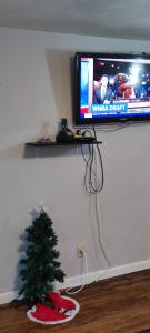 a television and a christmas tree on a shelf at Picon Homey in Springfield