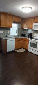 a kitchen with wooden cabinets and white appliances at Picon Homey in Springfield