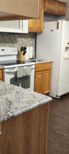 a kitchen with a white stove and a white refrigerator at Picon Homey in Springfield