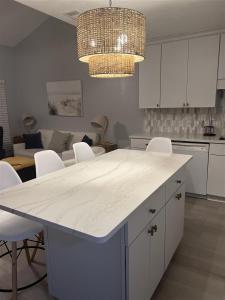 a kitchen with a white counter top and white cabinets at Isle Be Back in Destin