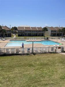a person standing in front of a swimming pool at Isle Be Back in Destin
