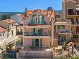 a large house with balconies on a city street at Anna's Cozy Home in Argostoli
