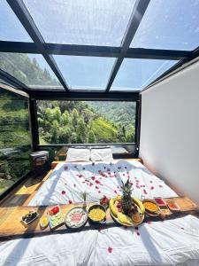 a bed with food on it in a room with a window at Northland Bungalows in Çayırdüzü