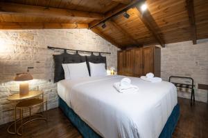 a bedroom with a large white bed in a room at Bodrum Suites in Ioannina
