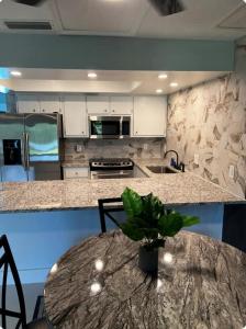 a kitchen with a table and a counter top at Luxe Waterfront home near beach in Fort Myers