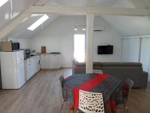 a living room with a table and a couch at QUIET PLACE in Biscarrosse