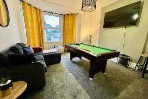 a living room with a pool table in it at Sophia's Retreat - 2 Floor 4 Bed Apartment - Newport - Coastal Getaway in Newport