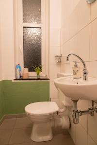 a bathroom with a toilet and a sink at Altes Pfarrhaus in Oberhausen