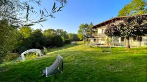 a yard with a house in the background at Maison entre lac et montagnes in Quintal