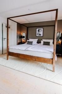 een groot bed met een houten frame in een slaapkamer bij Cottage Salzburg in Nußdorf am Haunsberg