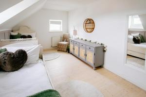 a bedroom with white walls and a bed and a window at Cottage Salzburg in Nußdorf am Haunsberg