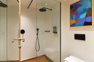 a shower with a glass door in a bathroom at Alai Crete a Tribute Portfolio Resort in Stalís