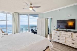 a bedroom with a bed and a flat screen tv at Palacio 1604 in Pensacola