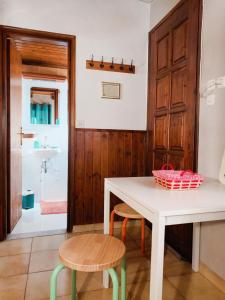 a kitchen with a table and two chairs and a bathroom at Garden's House in Spata