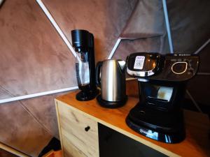 a coffee maker and a cup on a table at Glamping ZAZEN in Drumu Carului