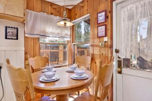 a dining room with a table and chairs and a window at JUS' RESTIN #265 in Big Bear Lake