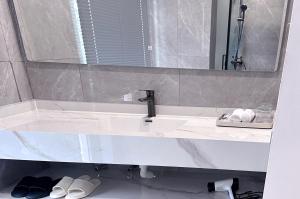 a bathroom with a sink and a mirror at No 33 Lodge in Dar es Salaam