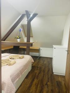 a bedroom with a bed and a wooden floor at Jenys Apartment Usti 2 in Ústí nad Labem