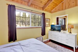 a bedroom with a bed and a dresser and a window at Lazy bear lodge #1235 in Big Bear Lake