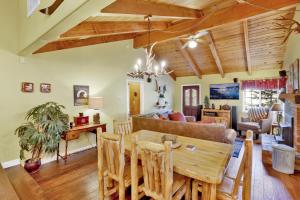 a dining room and living room with a wooden ceiling at Lazy bear lodge #1235 in Big Bear Lake