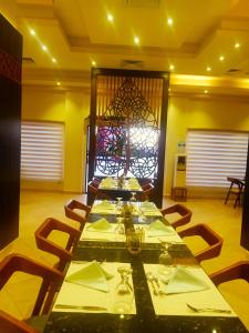 une salle à manger avec une grande table et des chaises dans l'établissement Oyster Bay Beach Suites, à Abu Dabab