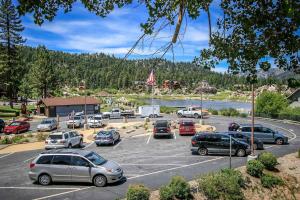 a parking lot with cars parked next to a lake at Boulder creek #1412 in Big Bear Lake