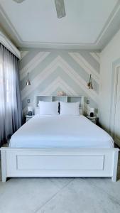 Ein Bett oder Betten in einem Zimmer der Unterkunft Villa Caprichosa Boutique Hotels