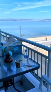 a table on a balcony with a view of the beach at Niko's Apartment - Beautiful Sea View Apartment ! in Perea