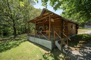 a small wooden cabin in a field with trees at Spring Hill Farm - The Happy Hound in Alma