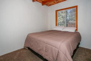 a bed in a white room with a window at Palms to pines #1877 in Sugarloaf