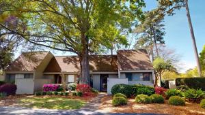 a house with a tree in the front yard at Magnolia Run 16 2BR 2BA in Pawleys Island