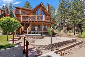 a large wooden house with a large deck on it at Cove lakefront chalet #2098 in Big Bear Lake