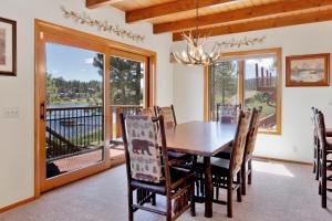 a dining room with a table and chairs and a balcony at Cove lakefront chalet #2098 in Big Bear Lake